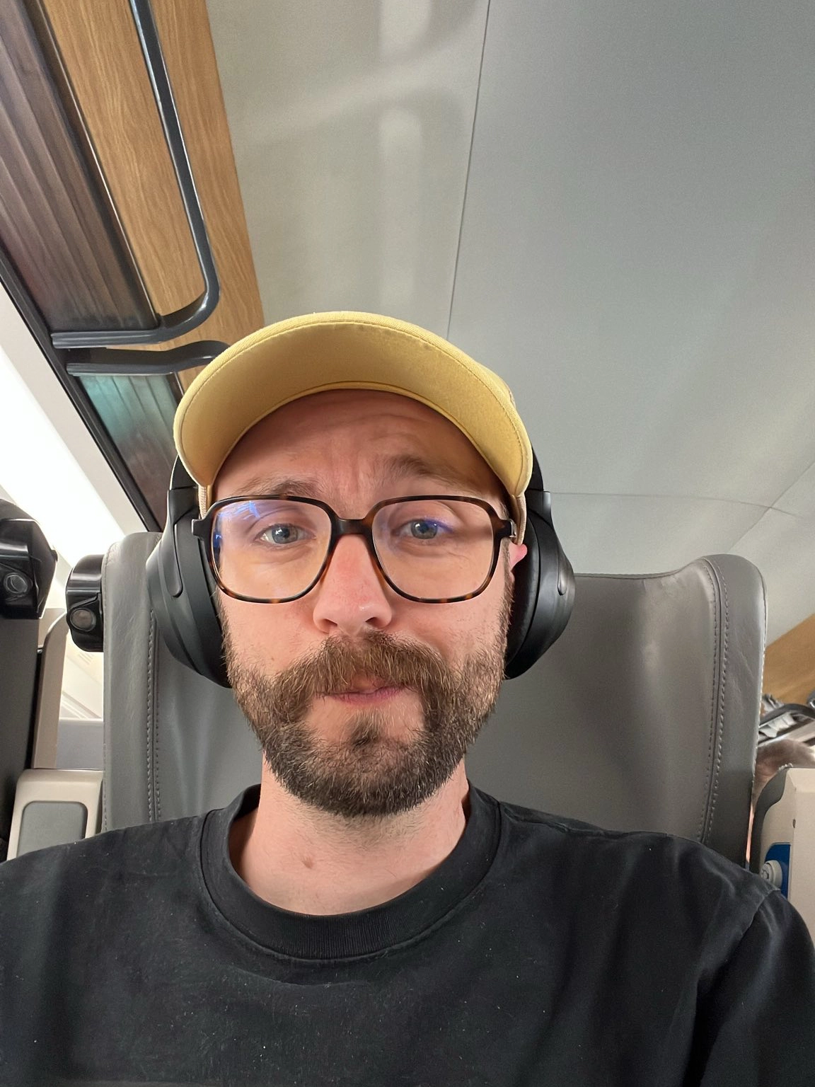 Sebastien Seguin in a train with a yellow hat and a headset